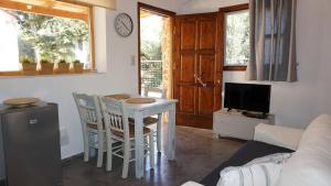 A television and/or entertainment centre at Studio Panagiota - Oasis holiday houses