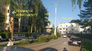 a street with cars parked on the side of the road at ROMANTIK APARTMENTS in Câmpulung Moldovenesc