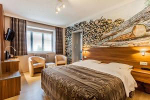 TV a/nebo společenská místnost v ubytování Hotel Fief De Liboichant