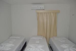 Säng eller sängar i ett rum på Loura Pousada