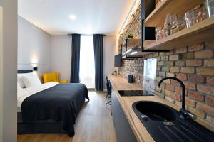 a bedroom with a bed and a brick wall at Imperial Apartment Z in Zagreb