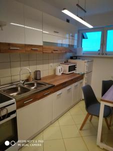 a small kitchen with a sink and a microwave at Apartament Briesen in Wąbrzeźno