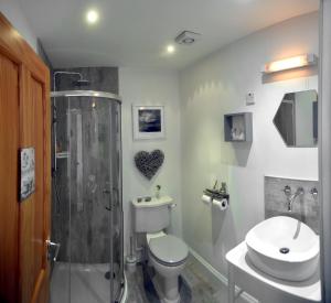 a bathroom with a shower and a toilet and a sink at Skye Photo Centre in Camastianavaig
