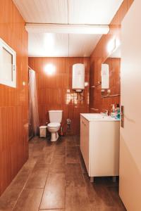 a bathroom with a toilet and a sink at Gaia Beach House in Vila Nova de Gaia