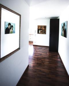 a hallway with two pictures on the wall and a mirror at Peter's in Koppl