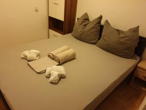 a bed with towels and pillows on it at Apartman Max in Sveti Ivan Zelina