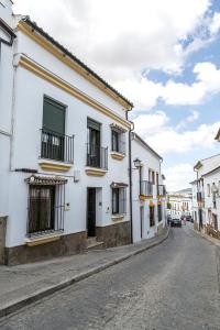 a street in a town with white buildings at Mafloras Suites El Bosque in El Bosque