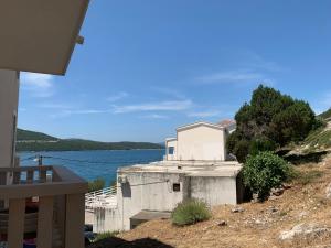 a house on a hill next to a body of water at Villa Slavka in Neum