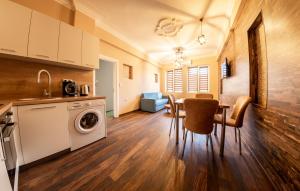 a kitchen and dining room with a table and a washing machine at Sofia Artist Life Apartment in Sofia
