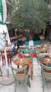 a group of tables and chairs and a tree at Kanigos 3 BR VIEW Center of Athens in Athens