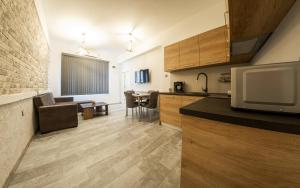 a kitchen and living room with a television and a table at Sofia Downtown Life Apartment in Sofia