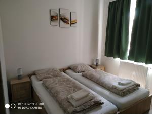 A bed or beds in a room at MATE Apartmanok