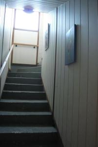 a hallway with stairs in a building with a window at GITE BORD DE MER in Bernières-sur-Mer