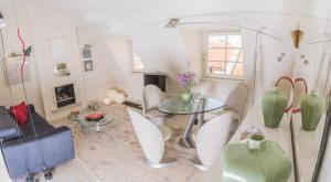 a living room with a glass table and chairs at President Boutique Apartment in Brno