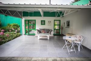 a patio with two white chairs and a table at Apartman Magnolia in Ivanić-Grad