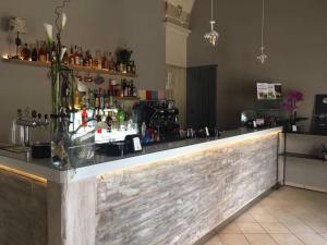 a bar in a room with a counter with bottles at Vico Cavour in Veglie
