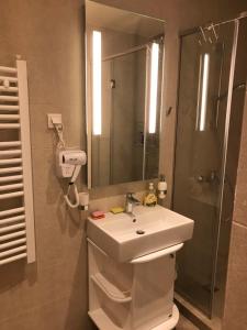 een badkamer met een witte wastafel en een douche bij Apartman Dragisic Kalman J15,D8 in Zlatibor