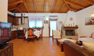a living room with a kitchen and a dining room at NEFELI VILLA in Patitiri