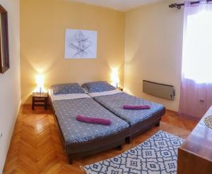 a bedroom with a bed with two pillows on it at Old Town Point in Budva