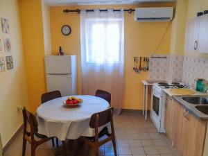 a kitchen with a table with a bowl of fruit on it at Old Town Point in Budva