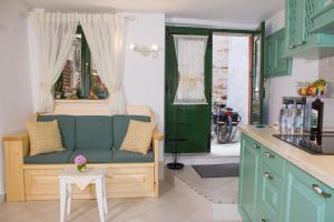 a living room with a couch in a kitchen at House Corte dei Matte' in Rovinj