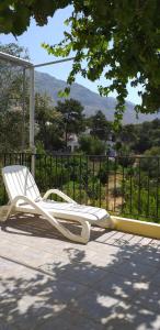 a white lounge chair sitting on a patio at Mela Studios in Panormos Kalymnos