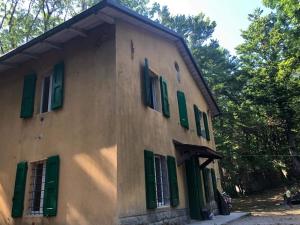 a building with green shuttered windows on it at CASA DELLE GUARDIE Rifugio in Madonna di Fornelli