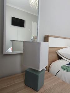 a computer monitor sitting on top of a bed at Ninho Jardim do Morro in Vila Nova de Gaia