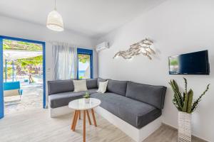 a living room with a couch and a table at Blue Paradise in Ierápetra