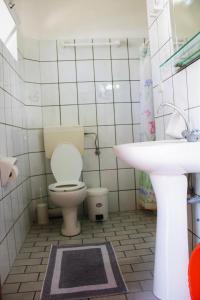 a bathroom with a toilet and a sink at Vrachos Holidays Hotel in Paralia Vrachou