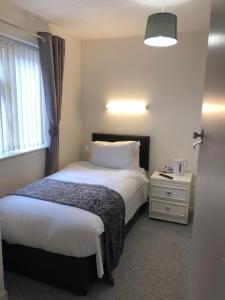 a hotel room with two beds and a window at The Bell Hotel in Newtown