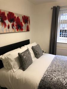 a bedroom with a white bed with two pillows at The Bell Hotel in Newtown