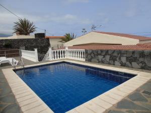 a swimming pool in front of a house at Casas Rita in Frontera