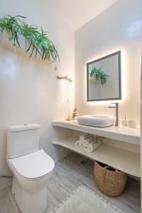 a bathroom with a toilet and a sink and a mirror at Blue Paradise in Ierápetra +38 photos