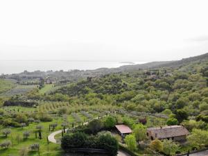 an aerial view of a valley with a house and a road at Agriturismo Panorama sul Lago in Passignano sul Trasimeno