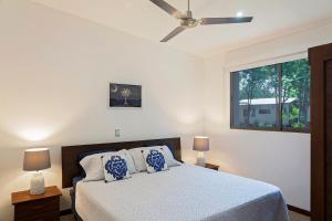 a bedroom with a bed with a ceiling fan at Eco Casita Phase III #2: Casa de Olas in Rivas