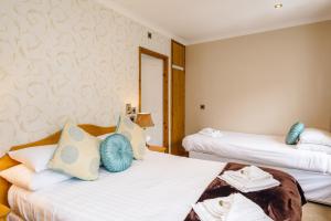 a bedroom with a bed and a dresser at Elan Hotel in Rhayader