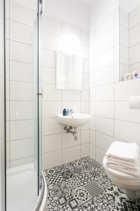 a bathroom with a toilet and a sink and a shower at Arenda in Karwia +33 photos