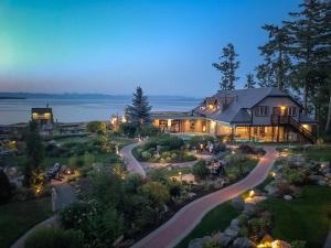 an aerial view of a house with a road leading to it at Kingfisher Pacific Resort & Spa in Courtenay