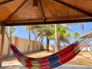 a hammock with palm trees in the background at Sleep'n'Ride in El Yaque