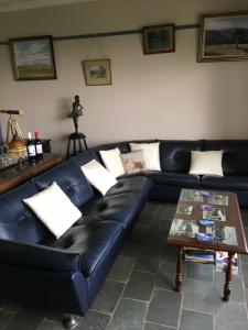 
a living room with a couch and a coffee table at Springmead B&B in Rydal
