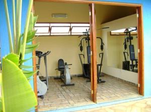 a gym with several exercise bikes and a mirror at Hotel Urubupunga in Ilha Solteira