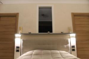 A bed or beds in a room at Villa Martina Luxury Rooms