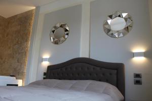 A bed or beds in a room at Villa Martina Luxury Rooms