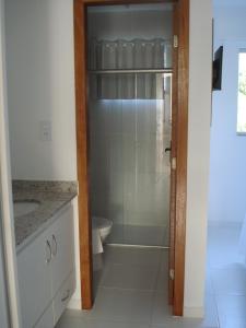 a bathroom with a shower and a sink and a toilet at Mont Carmelo Residencial Ap 5A Rede Tonziro in Porto Seguro