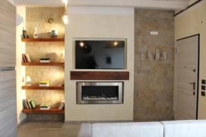 a living room with a tv and a fireplace at Villa Martina in Desenzano del Garda