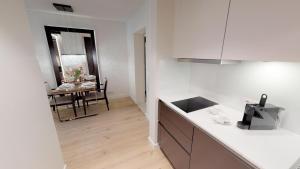 a kitchen with a counter and a dining room at White Pearl Apartment 1.10 in Timmendorfer Strand