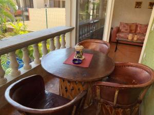 a table and chairs on a balcony with a cup of coffee at Hotel Condominium La Posada de Bucerias in Bucerías
