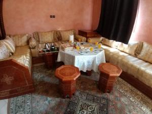 a living room with a table and a couch at Marrakech Family appartements in Marrakesh