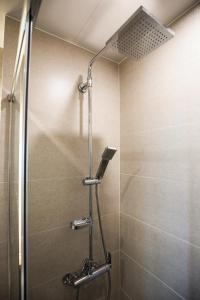 a shower with a glass door in a bathroom at Lemain Hotel in Jeju